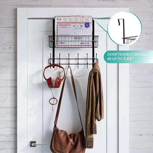 Wall-mounted organizer with hooks holding a bag, scarf, and headphones on a white door.