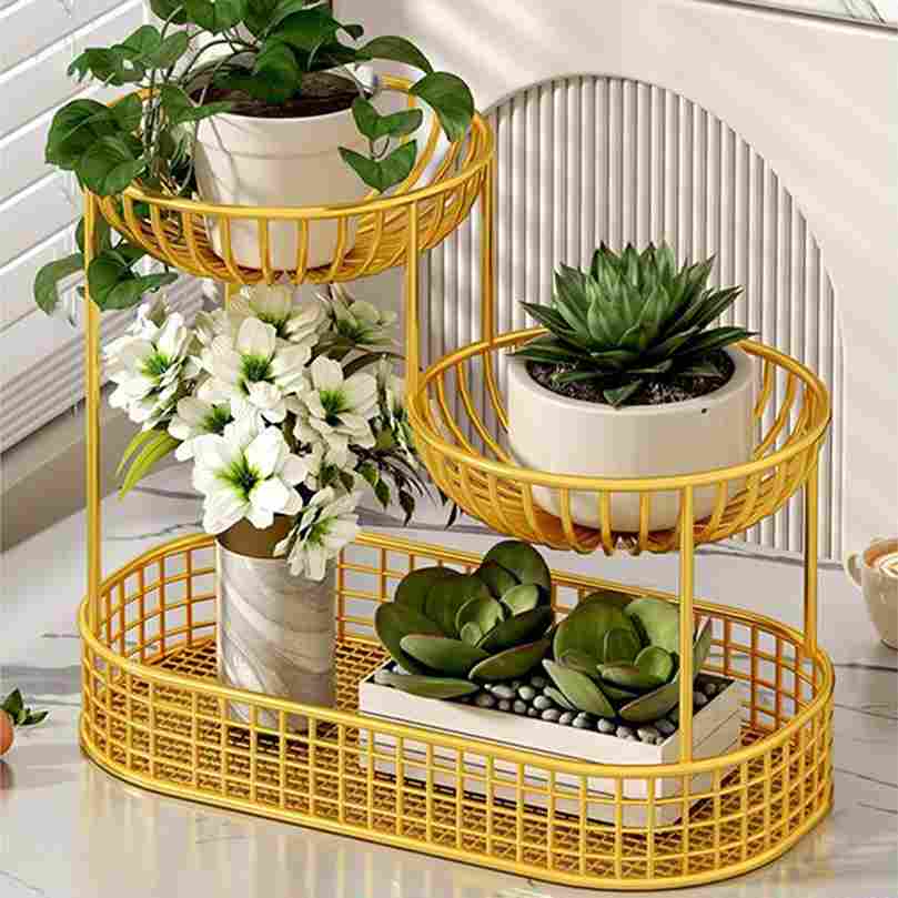 Yellow metal plant stand with various plants and flowers on a white surface.