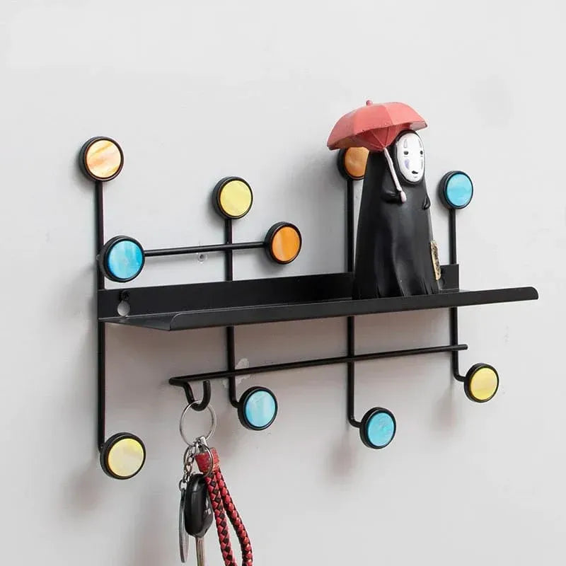 Close-up of metal hooks on Nordic-style wall shelf for keys, towels, or mugs