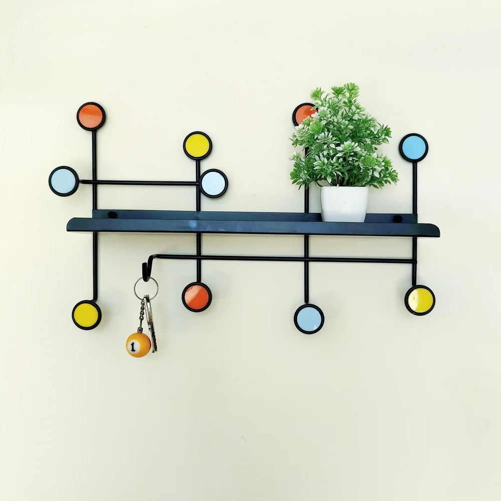 Wall shelf with hooks used in a kitchen setting holding mugs and spices