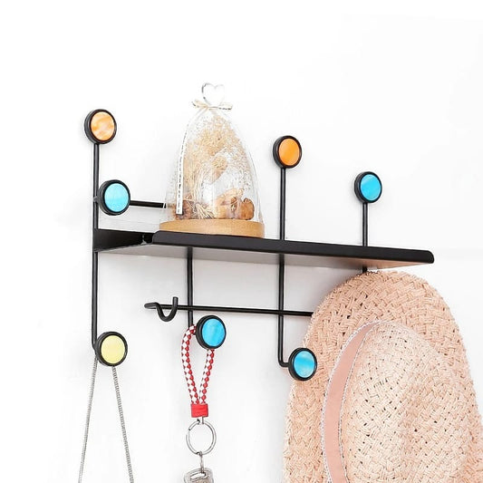 Front view of Nordic-style rectangular wall shelf with hooks mounted on a white wall