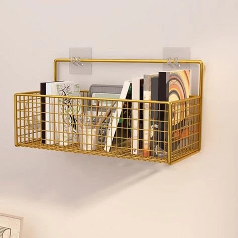 Gold wall-mounted wire basket with books and magazines