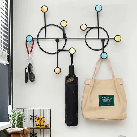 Front view of circular Nordic-style wall shelf with hooks mounted on wall